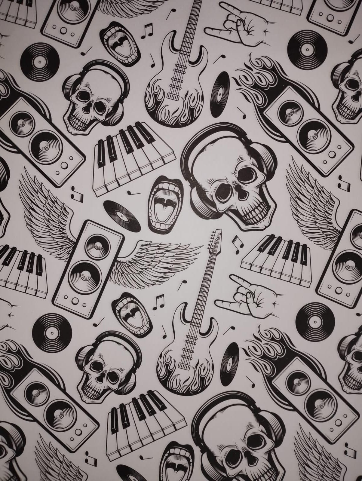 Papel de regalo obra calabera teclas guitarra 